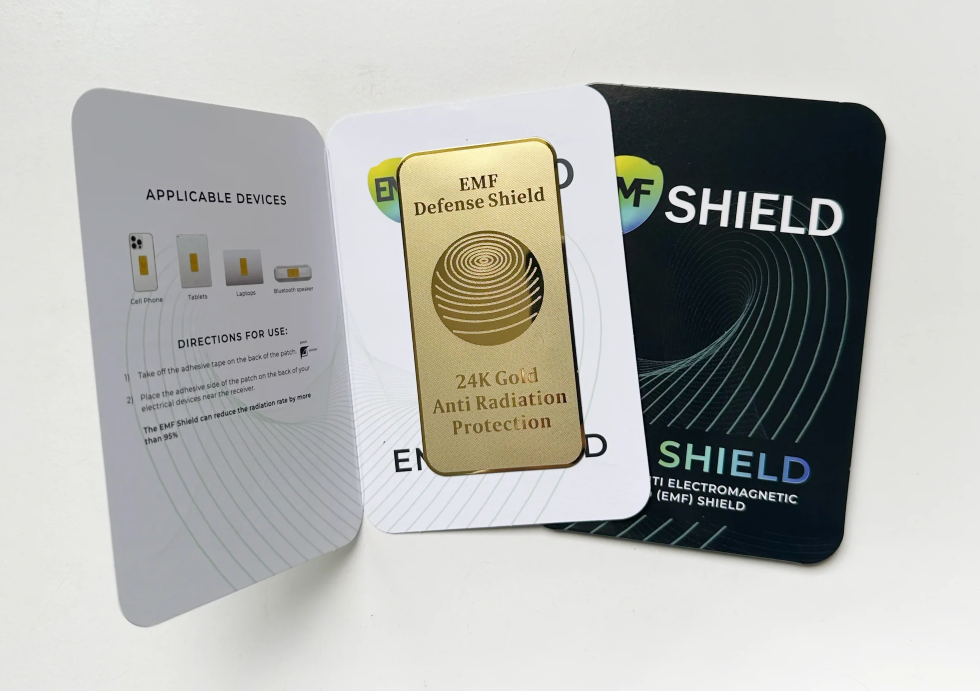 Three EMF shield cards with gold, black, and gray designs on a white background.