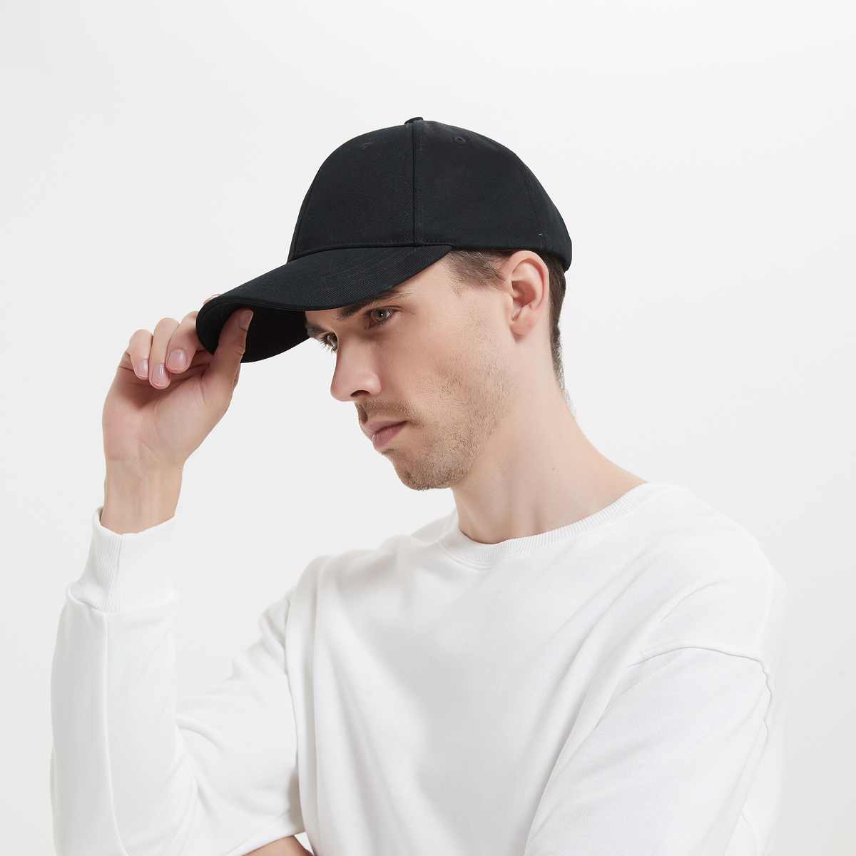 Man wearing a black cap on a white background